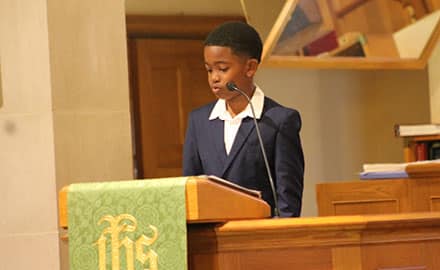 student giving speech at podium
