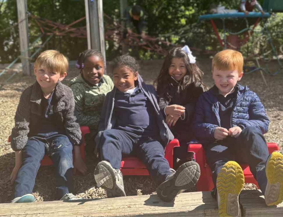 group of children smiling on playground